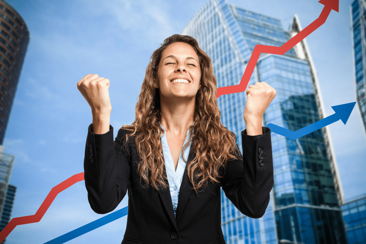 Smiling businesswoman in front of skyscrapers with red and blue upward arrows, symbolizing business growth and success.